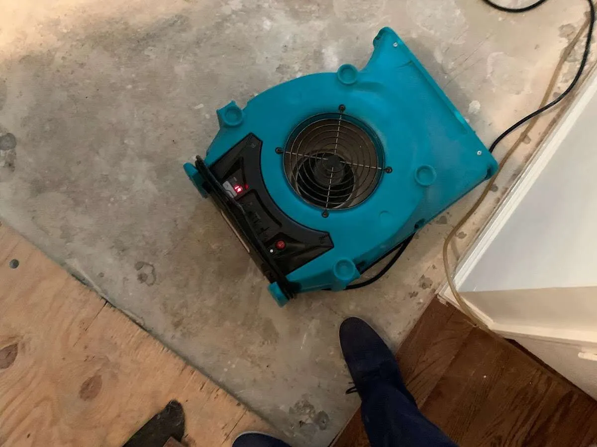 Air mover drying subfloor during Leak Detection & Repair in Jordan